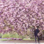 Georgianna Lane poses under a beautiful flowering tree.