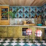a cabana bar gleams in hammered-brass cabinetry