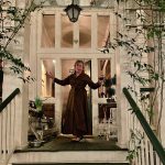Barbara Adkins standing in doorway on front porch