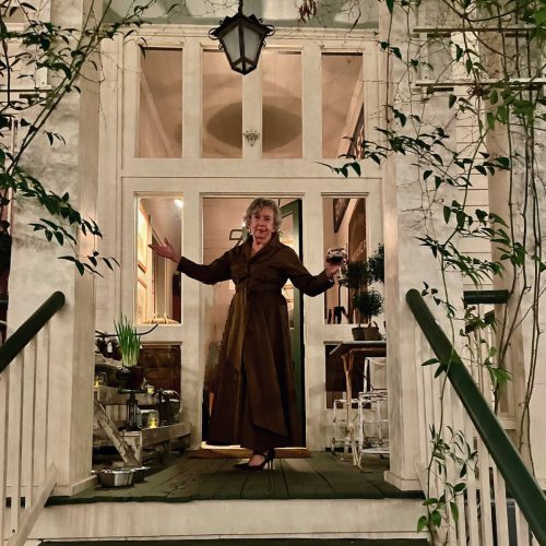 Barbara Adkins standing in doorway on front porch