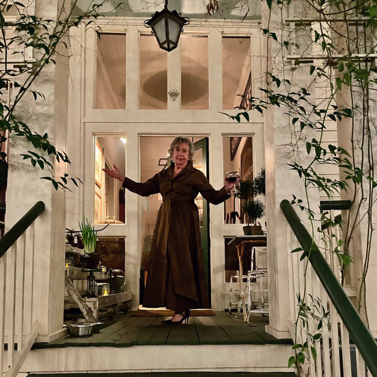 Barbara Adkins standing in doorway on front porch